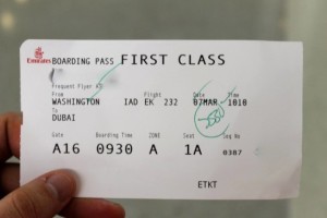 a hand holding a boarding pass