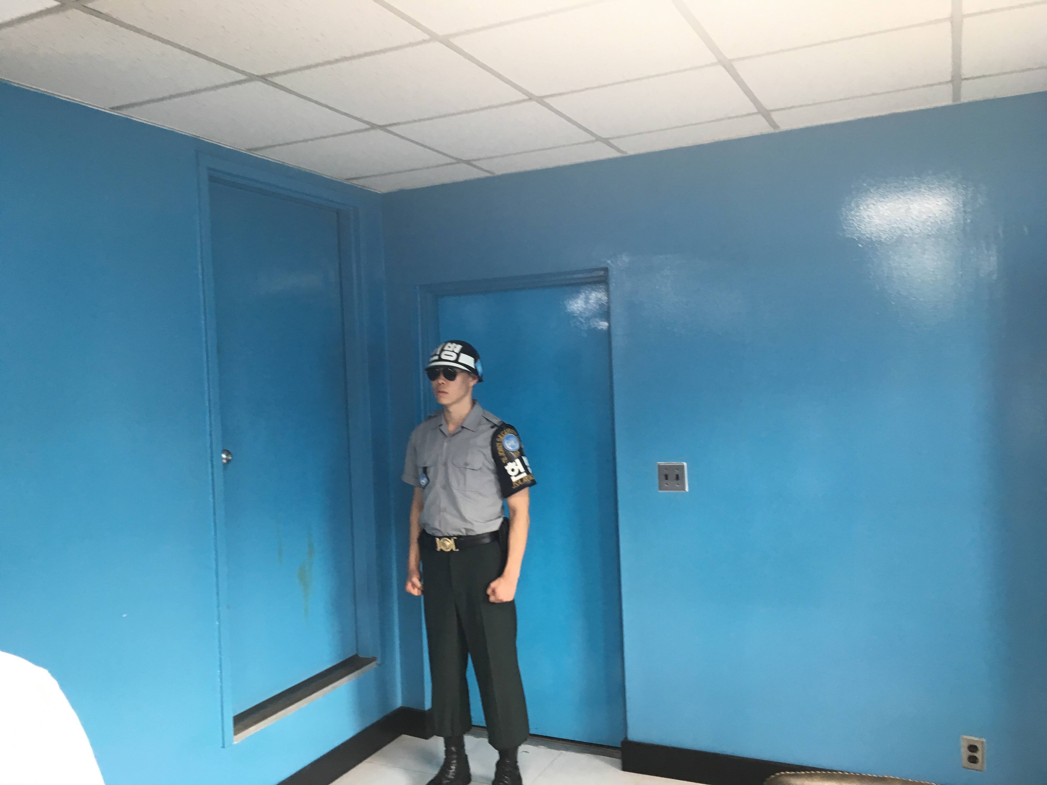 a man standing in a room with blue doors
