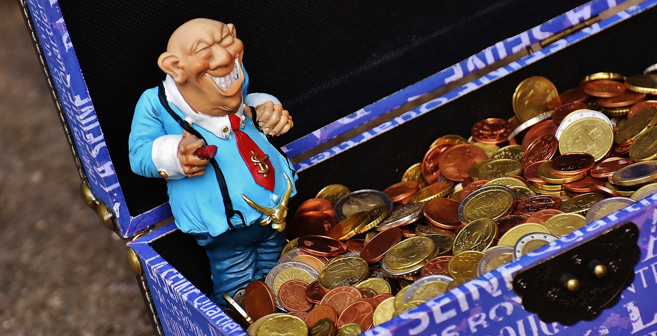 a toy figurine in a box of coins