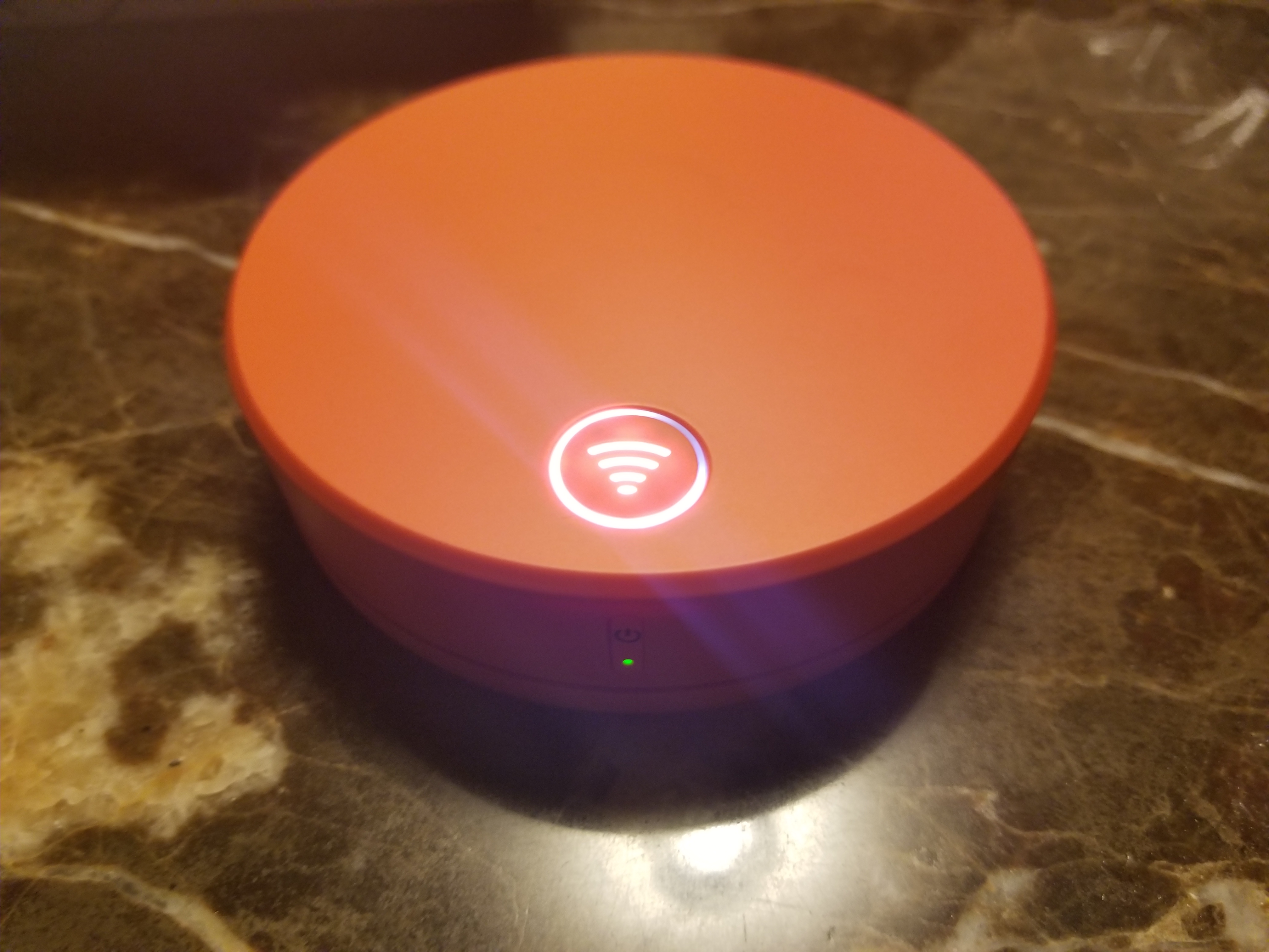 an orange round object with a wifi symbol on it
