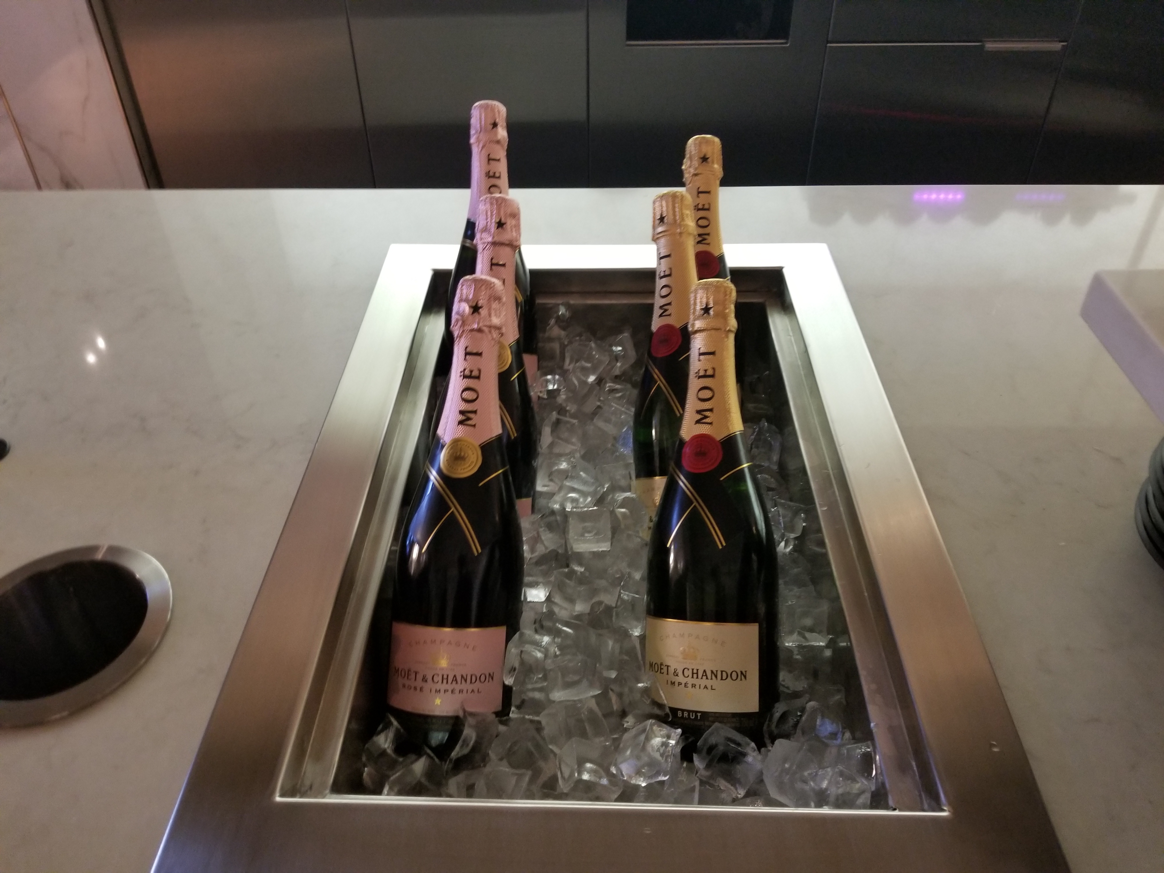 bottles of champagne in a metal tray with ice