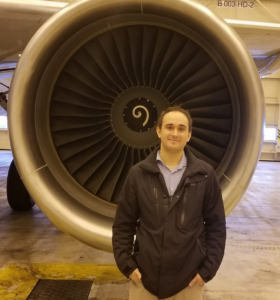 Avery in front of engine at Air Canada's Montreal headquarters